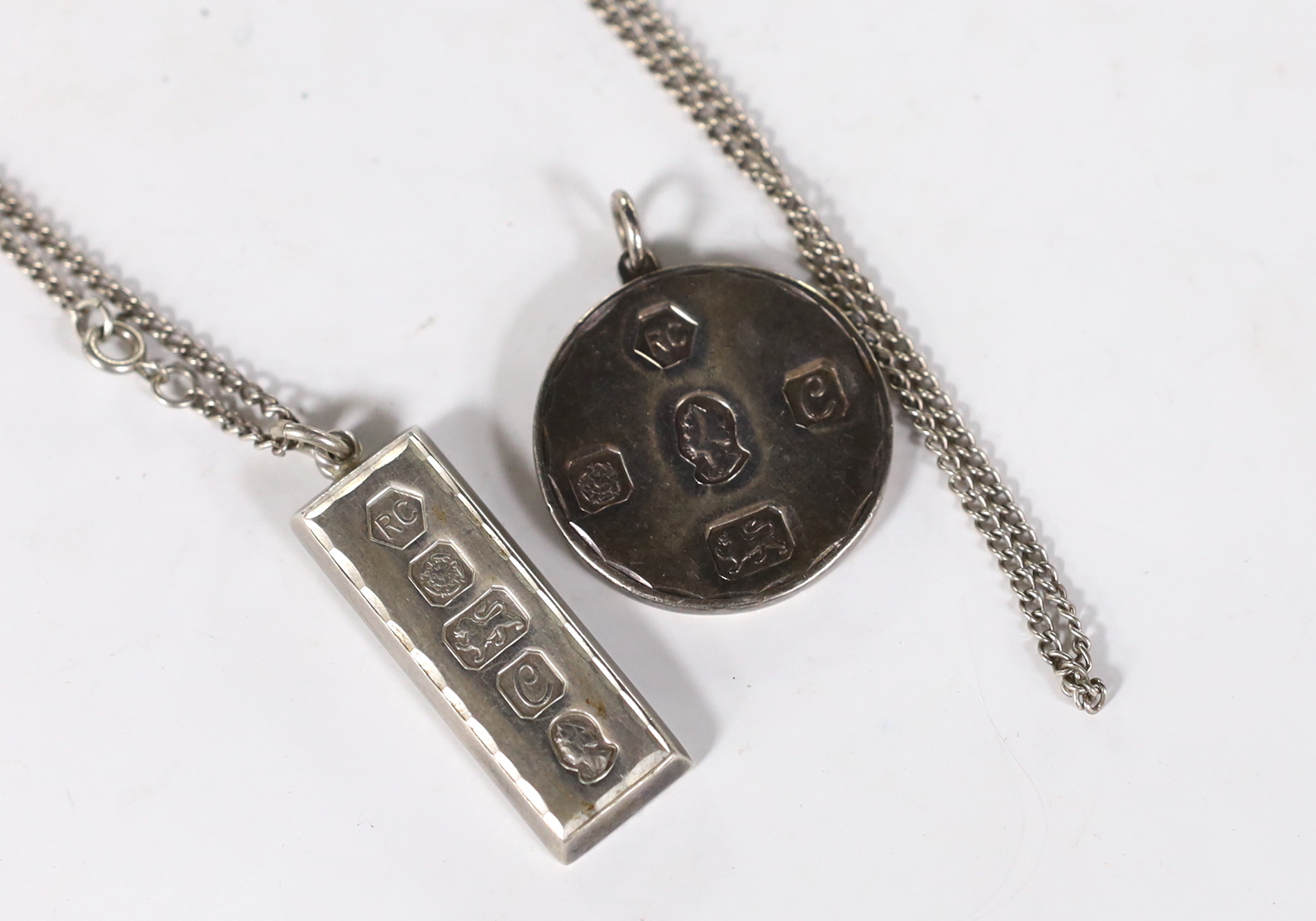 Two 1970's silver pendants, including ingot on a sterling chain, 40mm.